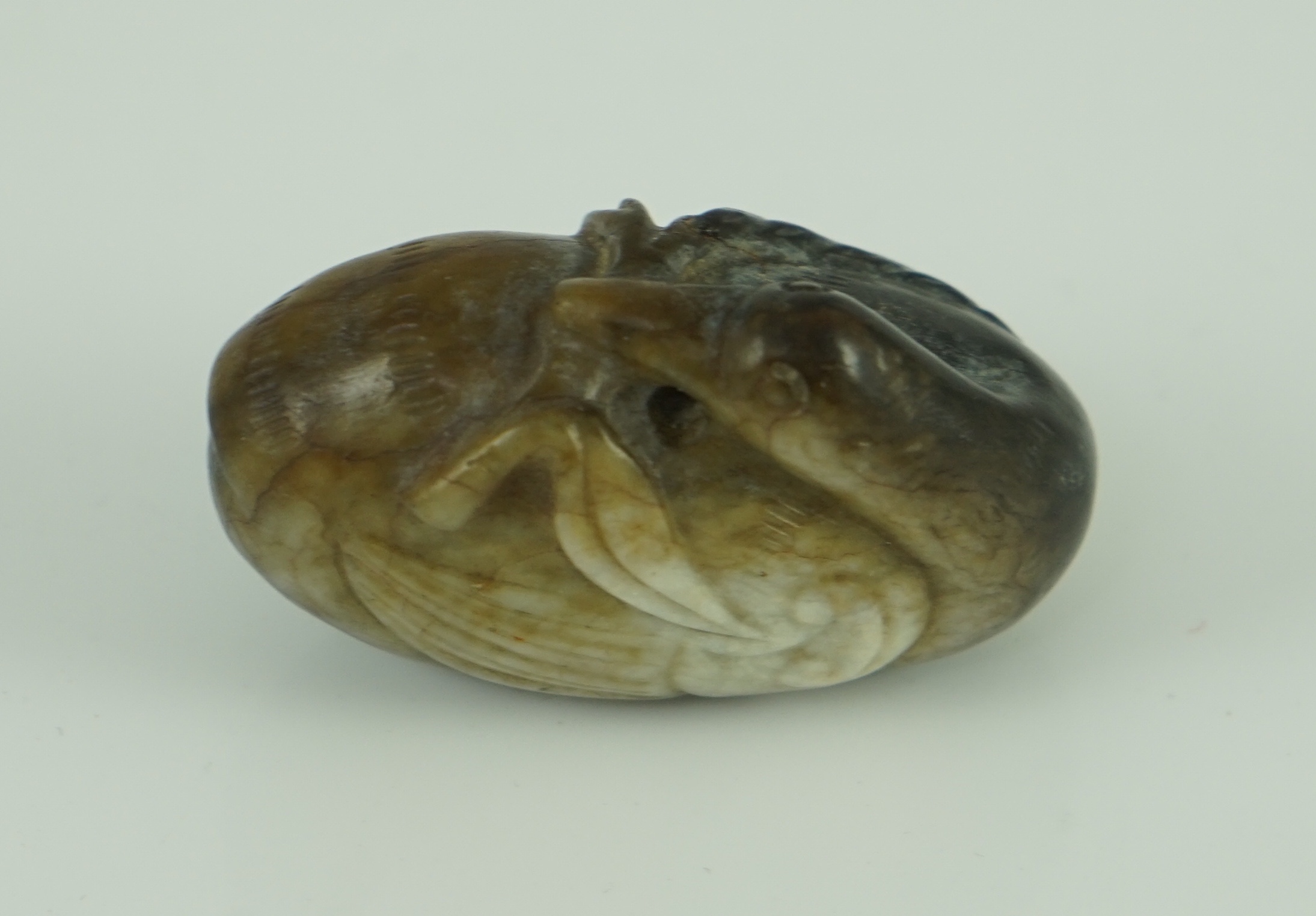 A Chinese white and black jade 'duck' pebble carving, Song dynasty or later 4.8 cm long